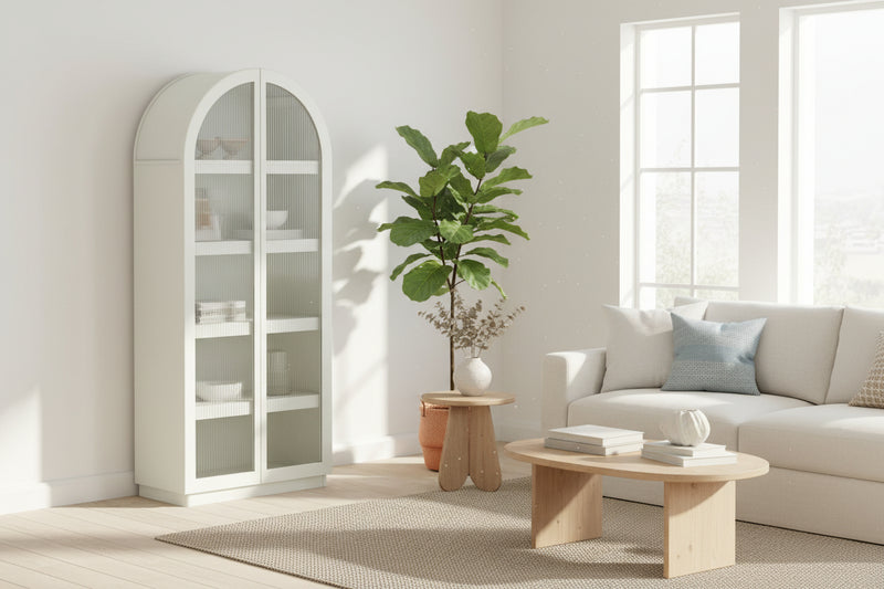 White arched bookshelf with glass panels on a white background