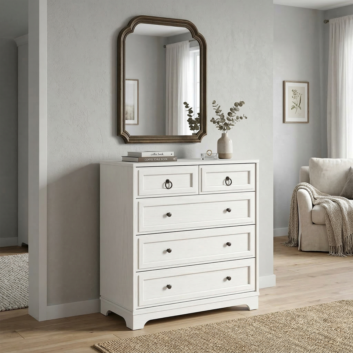 White dresser with multiple drawers in a room with a mirror and a sofa.