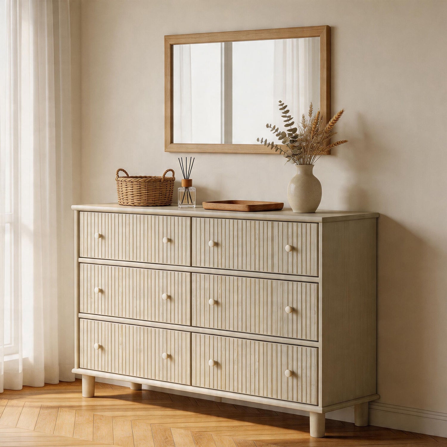 Beige dresser with decorative items in a room with a mirror and curtains.