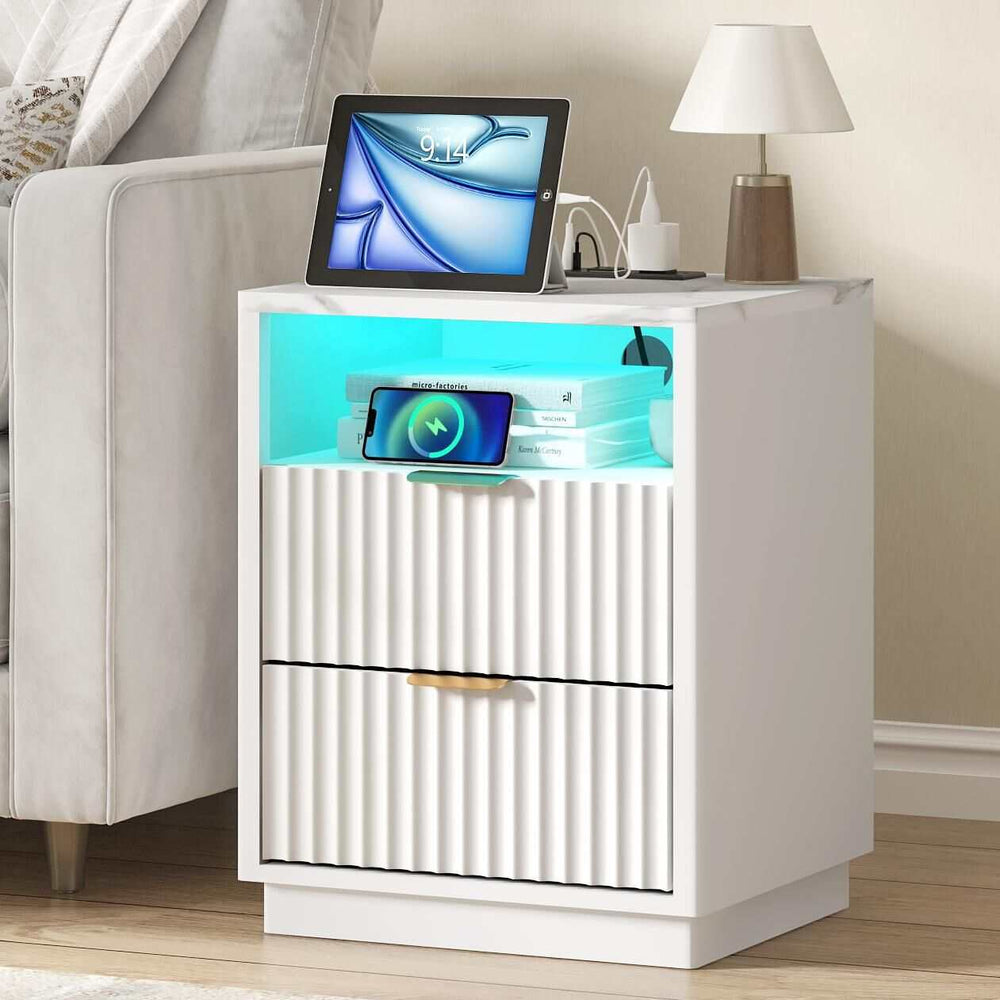 White RGB LED bedside table with USB charging, featuring two drawers, open top compartment, and white artificial marble finish.