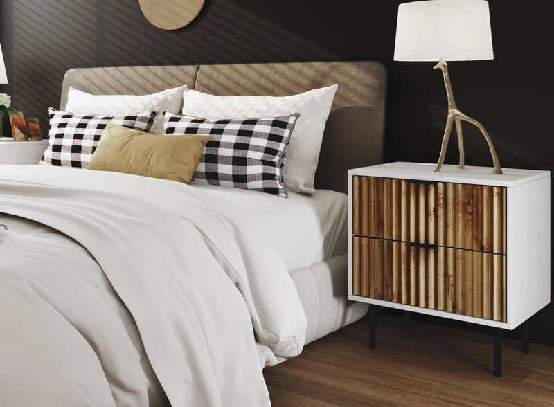 Chelsea 2-Drawer Bedside Table in bedroom setting, featuring white and wavy facade timber front, black handles, petite legs, mid-century modern design.