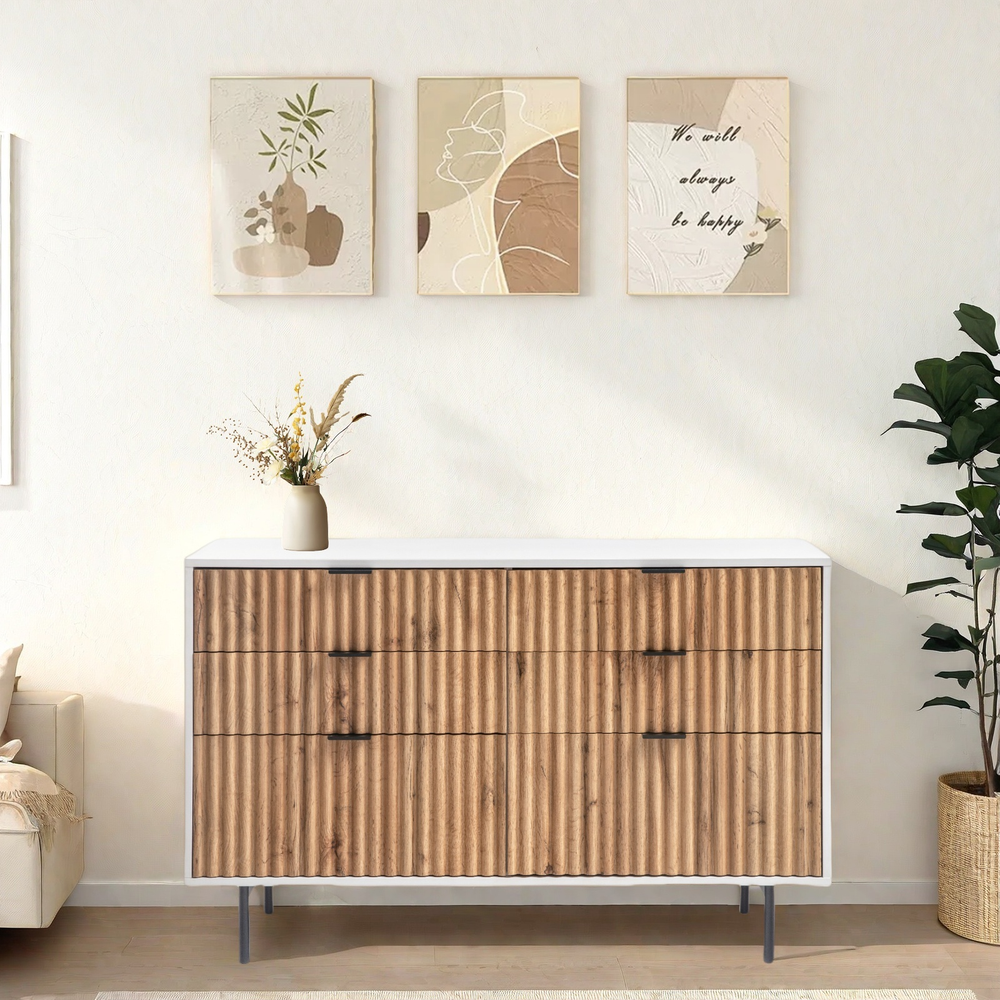 Chelsea 6-drawer dresser with white and wavy timber front, sleek black handles, and petite metal legs in a modern bedroom setting.
