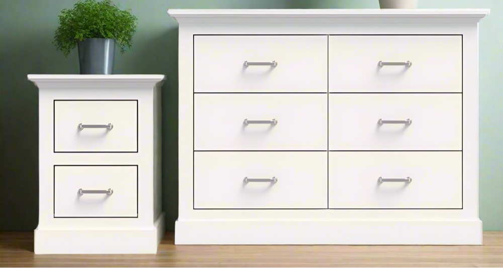 MerryLuk Ashford Chest of 6 Drawers white dresser and matching 2-drawer bedside table with silver handles on wooden floor against green wall.
