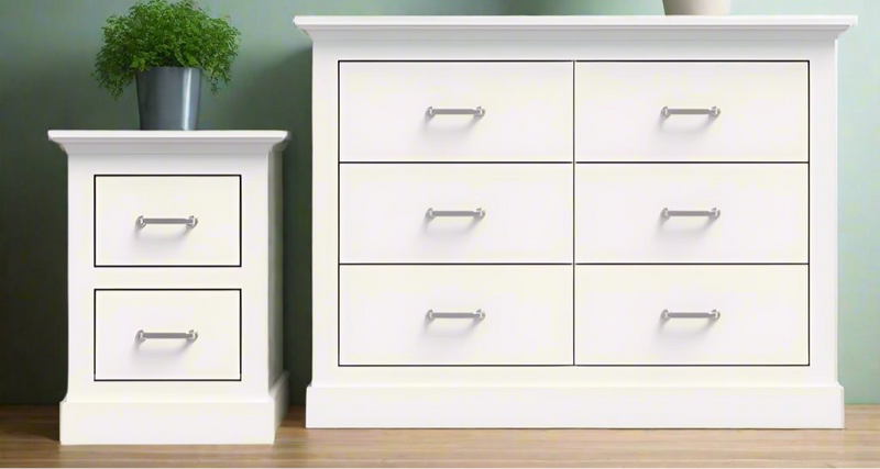 MerryLuk Ashford Chest of 6 Drawers white dresser and matching 2-drawer bedside table with silver handles on wooden floor against green wall.