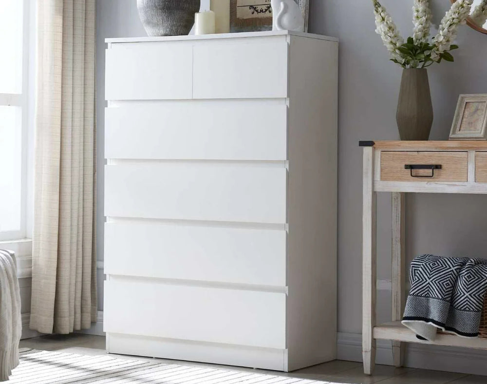 MerryLuk 6 DRAWERS Chest Tallboy, white modern dresser in bedroom setting with lamp and decor.