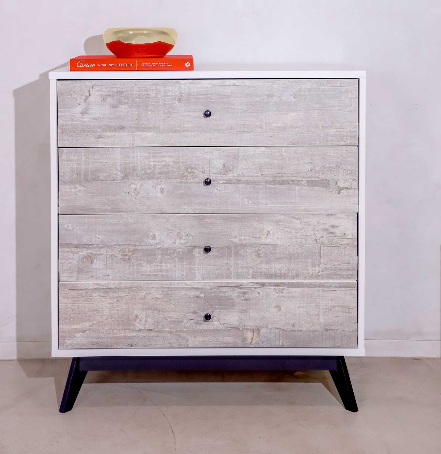 Rustic 4-drawer chest of drawers dresser with reclaimed wood finish and black tapered legs.